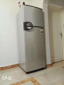 a stainless steel refrigerator in a corner of a room at Down Town apartment Nasr city in Cairo