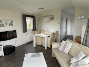 a living room with a couch and a table at Chalet 11 - Bergzicht Teuven in Teuven +9 photos