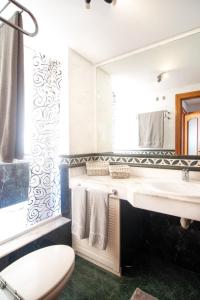 a bathroom with a sink and a toilet and a mirror at 2BR Home next to Esquinzo Beach - Terrace in Pájara