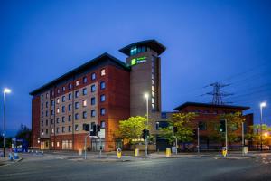 a building on a city street at night at Holiday Inn Express Leicester City by IHG in Leicester