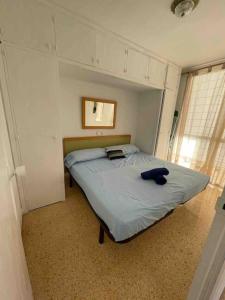- une chambre avec un lit doté d'un oreiller bleu dans l'établissement Beautiful residential apartment with pool, à Benidorm