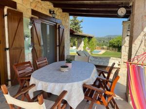 a table and chairs on the patio of a house at Jordan's Stone House in Siviri