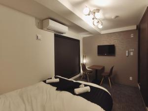 a hotel room with a bed and a table with chairs at West Japan Kyoto Kiyomizu in Kyoto