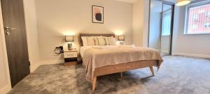 a bedroom with a bed and a table and a window at Seven Living Residences Slough - City Apartments, Free Parking in Slough