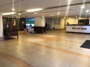 an empty lobby with a reception desk in a building at Beach Resort Home Stay SRI SAYANG APARTMENT BATU FERRINGHI 2BEDROOM in Batu Ferringhi +27 photos