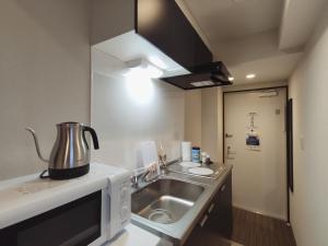 a kitchen with a sink and a pot on a counter at West Japan Kyoto Kiyomizu in Kyoto