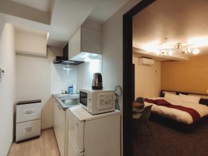 a small room with a kitchen and a bed at West Japan Kyoto Kiyomizu in Kyoto