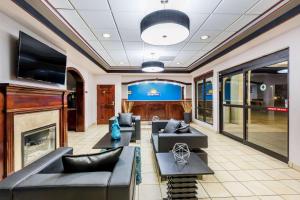 een lobby met banken, een open haard en een tv bij Days Inn by Wyndham Pearl/Jackson Airport in Pearl