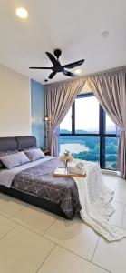 a bedroom with a bed with a ceiling fan at Astetica Pool & Lake View High Floor 100mbps Wifi Netflix in Seri Kembangan