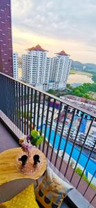 a balcony with a table and a view of a city at Astetica Pool & Lake View High Floor 100mbps Wifi Netflix in Seri Kembangan