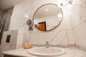 a bathroom with a sink and a mirror at Victoria Palas Hotel in Astrakhan