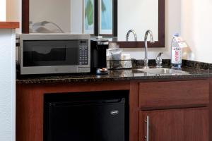 a kitchen with a microwave and a sink at Hyatt Place Memphis Primacy Parkway in Memphis