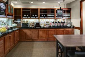 a bar in a restaurant with wooden cabinets and a counter at Hyatt Place Memphis Primacy Parkway in Memphis