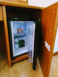 a small refrigerator with its door open in a kitchen at Hotel Ristorante Da Roverino in Comunanza