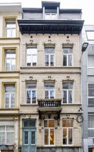 a large brick building with windows and a balcony at SHWAY - Le Lambermont in Antwerp