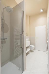 a bathroom with a glass shower and a toilet at SHWAY - Le Marnix in Antwerp +26 photos
