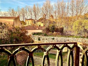 a bench in front of a stone wall at -- La Maisonette Casa Vacanze by Le Dimore del Borgo -- Graziosa casa a due passi dal parco Aymerich - Cucina - Dotazione biancheria - Tutti i comfort - Privacy libertà come stare a casa -Per coppie famiglie amici - Holiday Home with Kitchen in Làconi