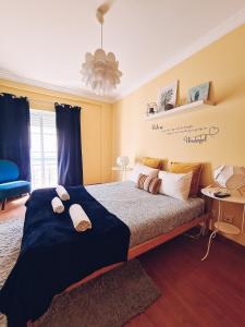 a bedroom with a large bed with two pillows on it at DOWNTOWN-Guest House in Olhão