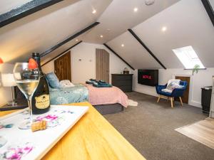 a bedroom with a bed and a table with a wine glass at Thomas Chambers in Camborne