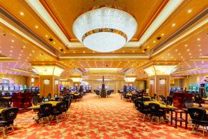 a banquet hall with tables and chairs and a chandelier at Grand Pasha Hotel & Spa Kyrenia in Kyrenia