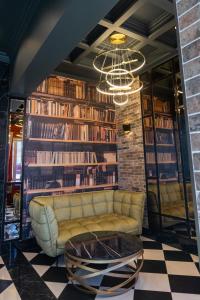 eine Bibliothek mit Sofa und Kronleuchter in der Unterkunft Old Bridge in Dnipro