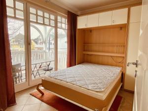 a bedroom with a bed in front of a window at Villa Laetitia - by Rujana in Binz