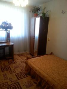 a bedroom with a bed and a dresser and a window at Квартира у Светы in Pizunda