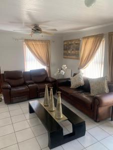 a living room with a couch and a coffee table at 5 bedroom home in Langebaan, located close to Club Mykanos and Laguna Mall in Langebaan