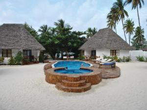 a resort with a swimming pool and two huts at Sea View Lodge Boutique Hotel in Jambiani