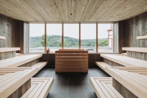 a large room with benches and a large window at Hotel & Spa Suiten FreiWerk in Stolberg i. Harz