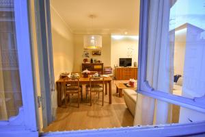 a kitchen and dining room with a table and chairs at Piccola Perla sul Lago Maggiore in Arona