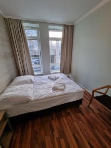 a bed in a room with a large window at Puschkin Rooms in Berlin