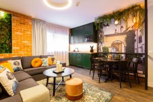 a living room with a couch and a kitchen at Fly Rooms Madrid Airport in Madrid