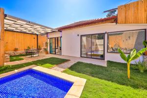 a backyard with a swimming pool and a house at Flower Hotel Patara in Patara