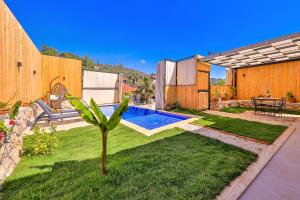 a backyard with a swimming pool and a garden at Flower Hotel Patara in Patara