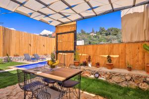 a patio with a table and chairs and a fence at Flower Hotel Patara in Patara