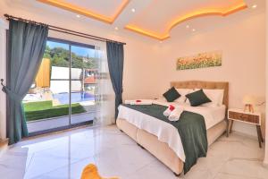 a bedroom with a bed and a large window at Flower Hotel Patara in Patara