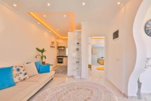 a living room with a couch and a table at Flower Hotel Patara in Patara