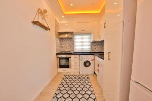a small kitchen with a washer and dryer at Flower Hotel Patara in Patara