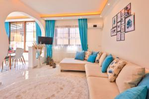 a living room with a couch and a table at Flower Hotel Patara in Patara