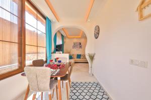 a kitchen and dining room with a table and chairs at Flower Hotel Patara in Patara