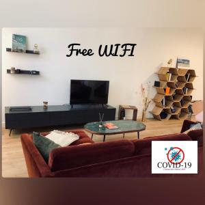 a living room with a couch and a coffee table at Home Sweet Home in Cognac