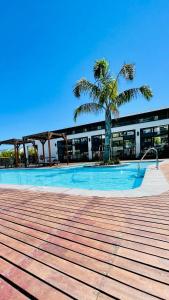 a building with a swimming pool with a palm tree at 417 The Sandown in Cape Town