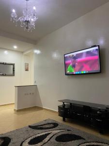 a living room with a flat screen tv on a wall at Mohammed V International Airport HOUSE in Nouaseur