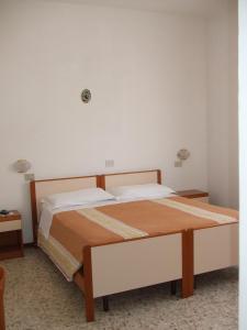 Postel nebo postele na pokoji v ubytování Albergo La Primula