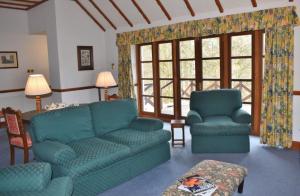 a living room with a couch and two chairs at Jock Scott Cottage in Dunkeld
