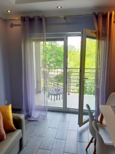 a living room with a sliding glass door at Na Grobli in Wrocław