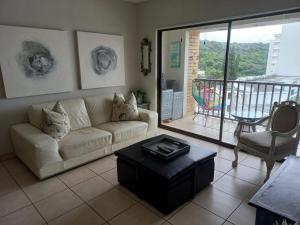 a living room with a couch and a table at 305 Hawaan View in Durban