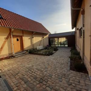 a stone driveway in front of a building at Boerderaaj in Bilzen