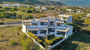 an aerial view of a white house at To Pithari in Skiros